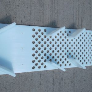 CNC machined nylon feed chute for a vibratory polishing machine.